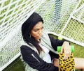 Cool pretty smiling afro-american happy young woman with skate b Royalty Free Stock Photo