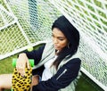 Cool pretty smiling afro-american happy young woman with skate b Royalty Free Stock Photo