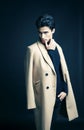 Cool real young man in coat on black background posing, lifestyle people concept Royalty Free Stock Photo