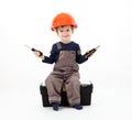 Cool repairman in hardhat with pliers and screwdriver on white