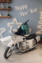 Cool retro motorcycle with Christmas presents. Motorcycle with gifts in decorated room. Royalty Free Stock Photo