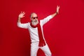 Cool santa character aged man drunk dancing at night club wear sun specs knitted clothes isolated red background