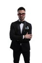 Cool sexy businessman in tuxedo crossing arms