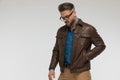 Cool sexy man with casual clothes and eyeglasses holding hand in jacket pocket Royalty Free Stock Photo