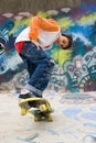 Cool skater against a graffiti wall