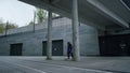 Cool skater making trick on skateboard outside. Sporty man jumping on longboard.