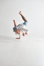 Cool smiling guy breakdancer dancing lower break dance shows thumbs up isolated on white background. Dance school poster Royalty Free Stock Photo