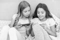 Cool sms. Small girls read sms in bed. Texting sms using smartphone. Sms message. Short message service. Text messaging Royalty Free Stock Photo