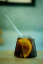Cool soft drink with orange slices inside glass