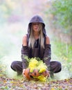 Stylish girl in the forest with pumpkin filled with colored smoke. Haloween concept. Royalty Free Stock Photo