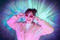 Cool teenager. Fashionable girl in pink sport trendy jacket and vintage retro sunglasses enjoys style of 80s - 90s vibes Royalty Free Stock Photo