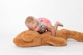 Cool toddler girl is lying on a big plush toy Royalty Free Stock Photo