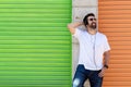 Cool trendy funny beard man in headphones listening music on colored background Royalty Free Stock Photo