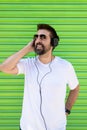 Cool trendy funny beard man in headphones listening music on colored background Royalty Free Stock Photo