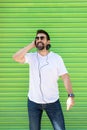Cool trendy funny beard man in headphones listening music on colored background Royalty Free Stock Photo