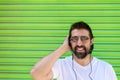 Cool trendy funny beard man in headphones listening music on colored background Royalty Free Stock Photo