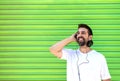 Cool trendy funny beard man in headphones listening music on colored background Royalty Free Stock Photo