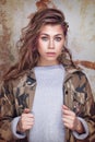 Cool trendy girl in camouflage jacket