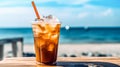Iced coffee sits enticingly on a cafe table with a beach backdrop Royalty Free Stock Photo