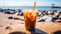 Iced coffee sits enticingly on a cafe table with a beach backdrop Royalty Free Stock Photo