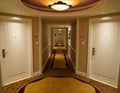 Cool view of a bright and empty corridor of a luxury hotel and closed doors.