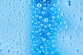Cool water and water drops on a blue plastic bottle . Selective focus. Royalty Free Stock Photo