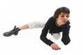 Cool well-stretched flexible young adult woman posing on the ground with one leg straight. Looking at camera. White Royalty Free Stock Photo