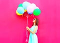 Cool woman is looking on an air colorful balloons having fun Royalty Free Stock Photo