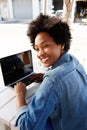 Cool young african woman working on laptop at outdoor cafe Royalty Free Stock Photo