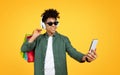 Cool young black guy enjoying shopping, taking selfie on smartphone Royalty Free Stock Photo