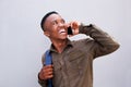 Cool young black guy laughing and talking on cellphone Royalty Free Stock Photo