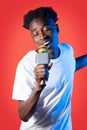 Cool young black guy with microphone in his hand singing Royalty Free Stock Photo