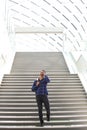 Cool young black guy on stairs talking on cell phone Royalty Free Stock Photo