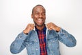 Cool young black male fashion model smiling with denim jacket Royalty Free Stock Photo
