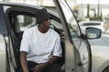 Cool young black male in a street style outfit posing in a car Royalty Free Stock Photo