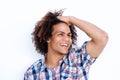 Cool young black man laughing with hand in hair