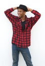 Cool young black man posing in checkered shirt and hat Royalty Free Stock Photo