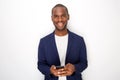 Cool young black man smiling with mobile phone against white background Royalty Free Stock Photo