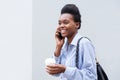 Cool young black woman walking and talking on cell phone Royalty Free Stock Photo