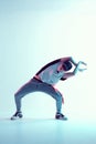 Cool young breakdancer guy dance in studio in neon light. Dance school poster