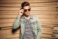 Cool young casual man taking off his sunglasses Royalty Free Stock Photo