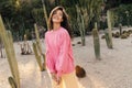 Cool young caucasian woman tilted her head to side looks away and stands alone in desert with cacti. Royalty Free Stock Photo