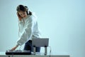 Cool young girl DJ mixes music on a mixing console and laptop, in stylish clothes, on white blue background.
