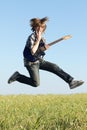 Cool young guitarist jumping Royalty Free Stock Photo