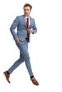 Cool young guy holding hand in pocket and unbuttoning blue suit Royalty Free Stock Photo