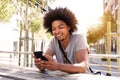 Cool young guy sitting outside with mobile phone Royalty Free Stock Photo