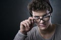 Cool young man adjusting his glasses Royalty Free Stock Photo