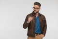 Cool young man with brown leather jacket looking to side Royalty Free Stock Photo