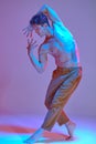 Cool young man dancing expressive dance without shirt in neon light. Colorful dance school poster Royalty Free Stock Photo