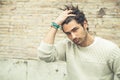 Cool young man fashion model, hairstyle. Hand in the hair Royalty Free Stock Photo